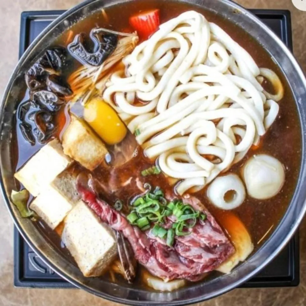 Savory beef udon hot pot with tofu and mushrooms at Uniboil Phresh Teas Co, a Hot Pot Restaurant in Goleta.