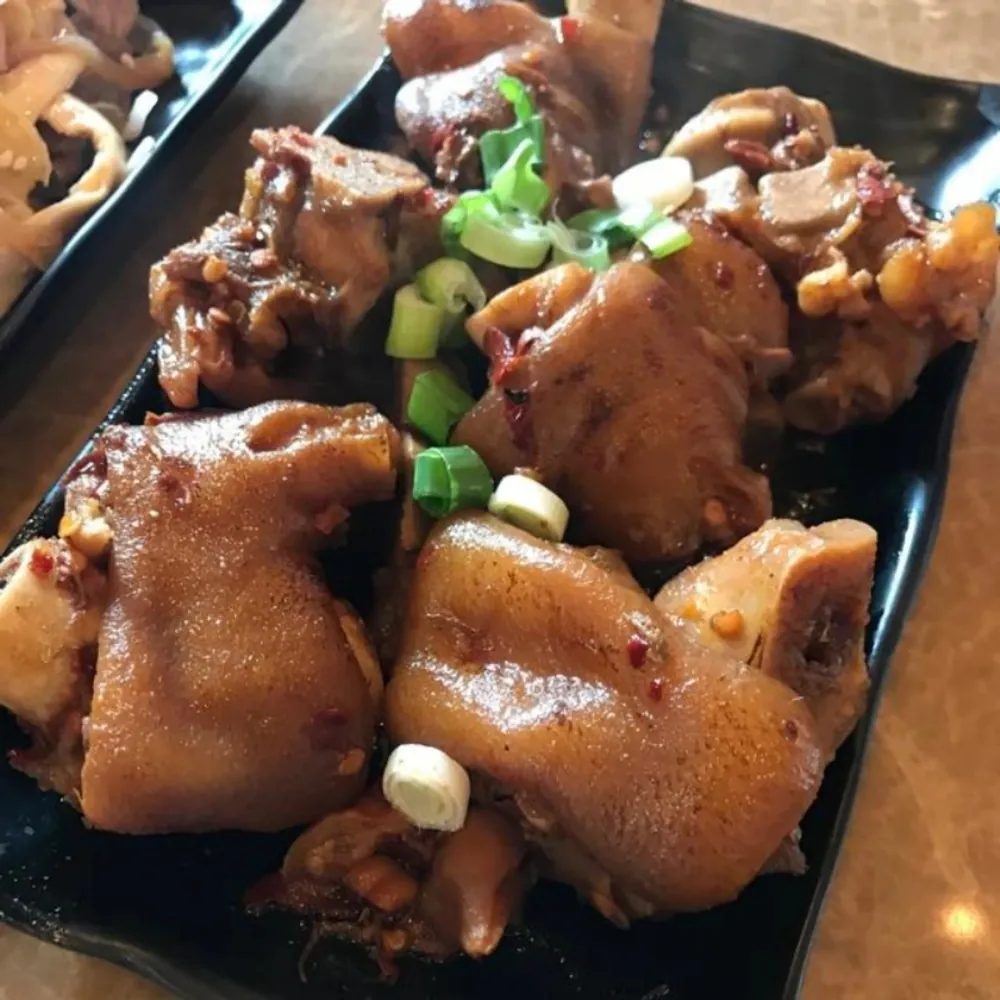 Braised pork hocks with spicy sauce and green onions at Uniboil Phresh Teas Co, a Hot Pot Restaurant in Goleta.