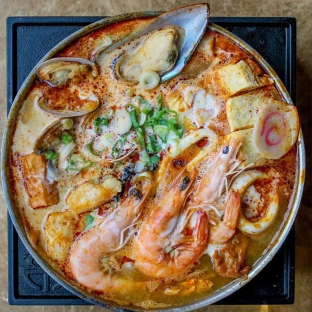 Spicy tom yum seafood hot pot with shrimp and mussels at Uniboil Phresh Teas Co, a Hot Pot Restaurant in Goleta.
