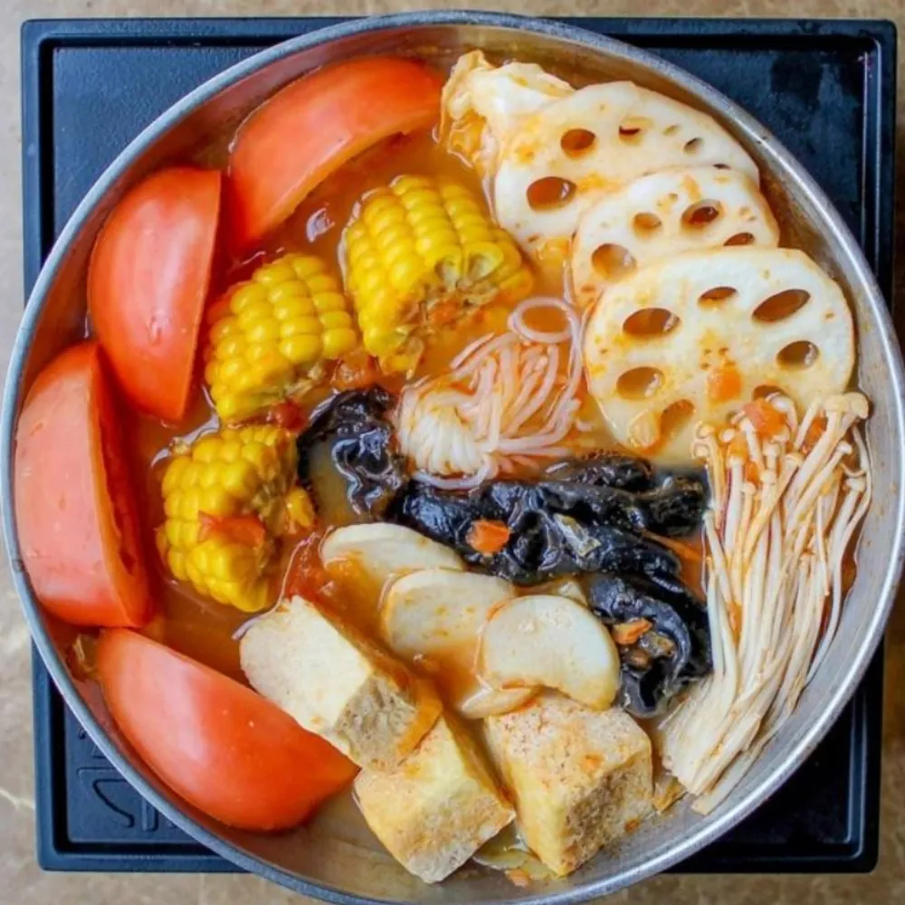 Fresh tomato vegetable hot pot with corn and lotus root at Uniboil Phresh Teas Co, a Hot Pot Restaurant in Goleta.
